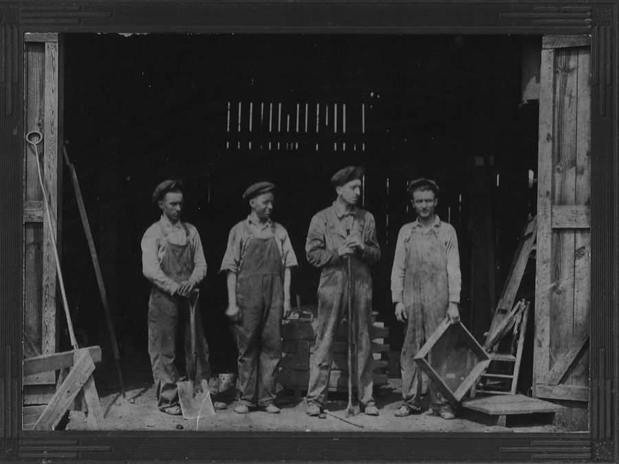 John Baker, second from left standing in main foundry door way. Circa early 1930’s.